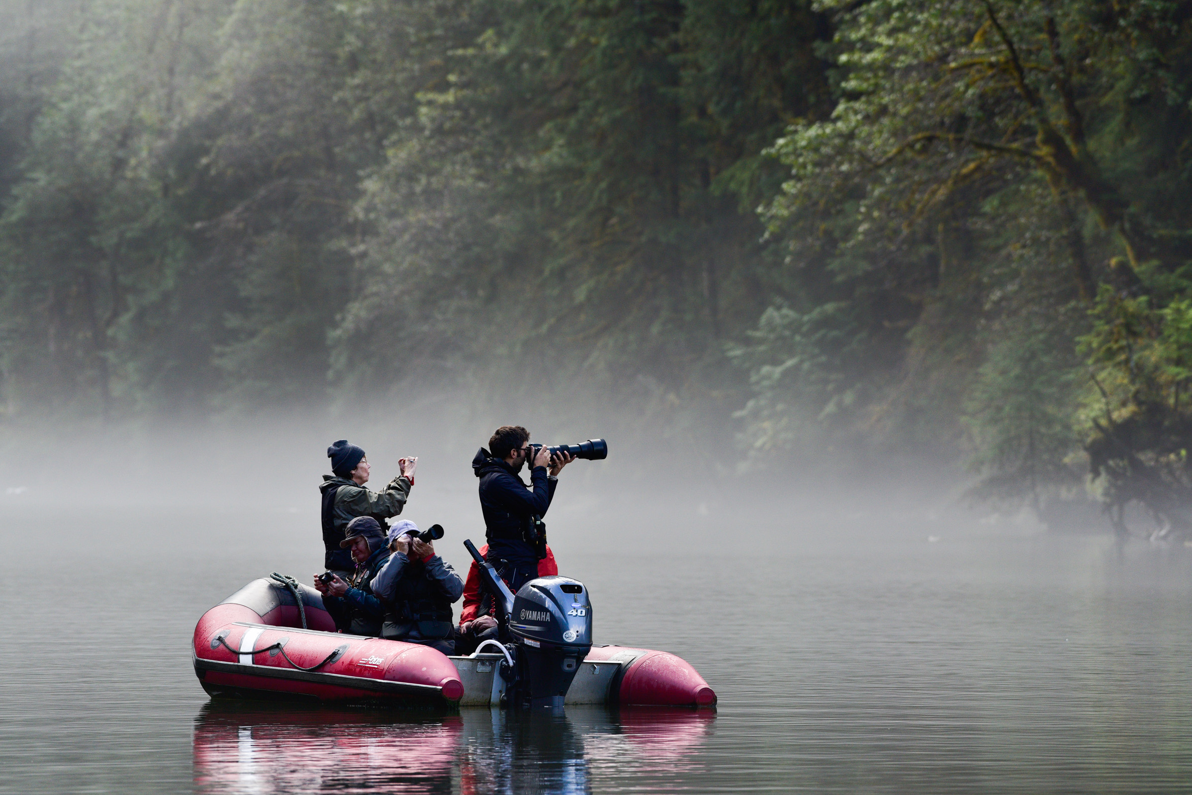 Photographing the scene in a tranquil tidal river channel in the Great Bear Rainforest.